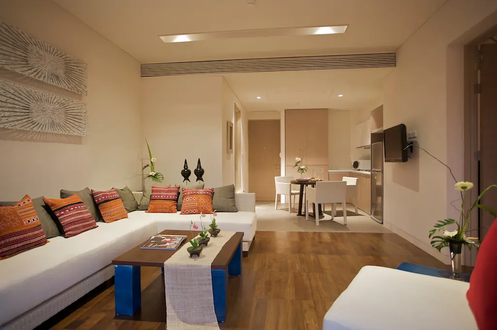 Bedroom side view displaying elegant lighting and calming resort surroundings.