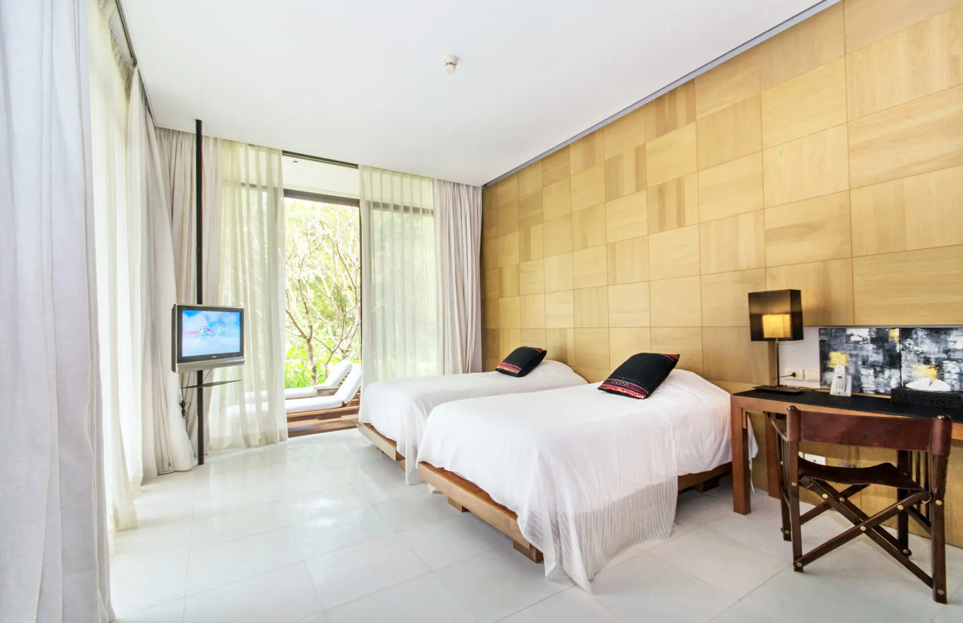 Stylish villa living room with large windows showcasing the natural surroundings.
