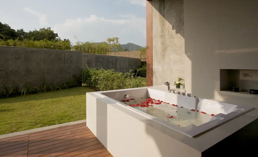 Bright master bedroom featuring premium bedding and calming views of Chiang Mai’s greenery.