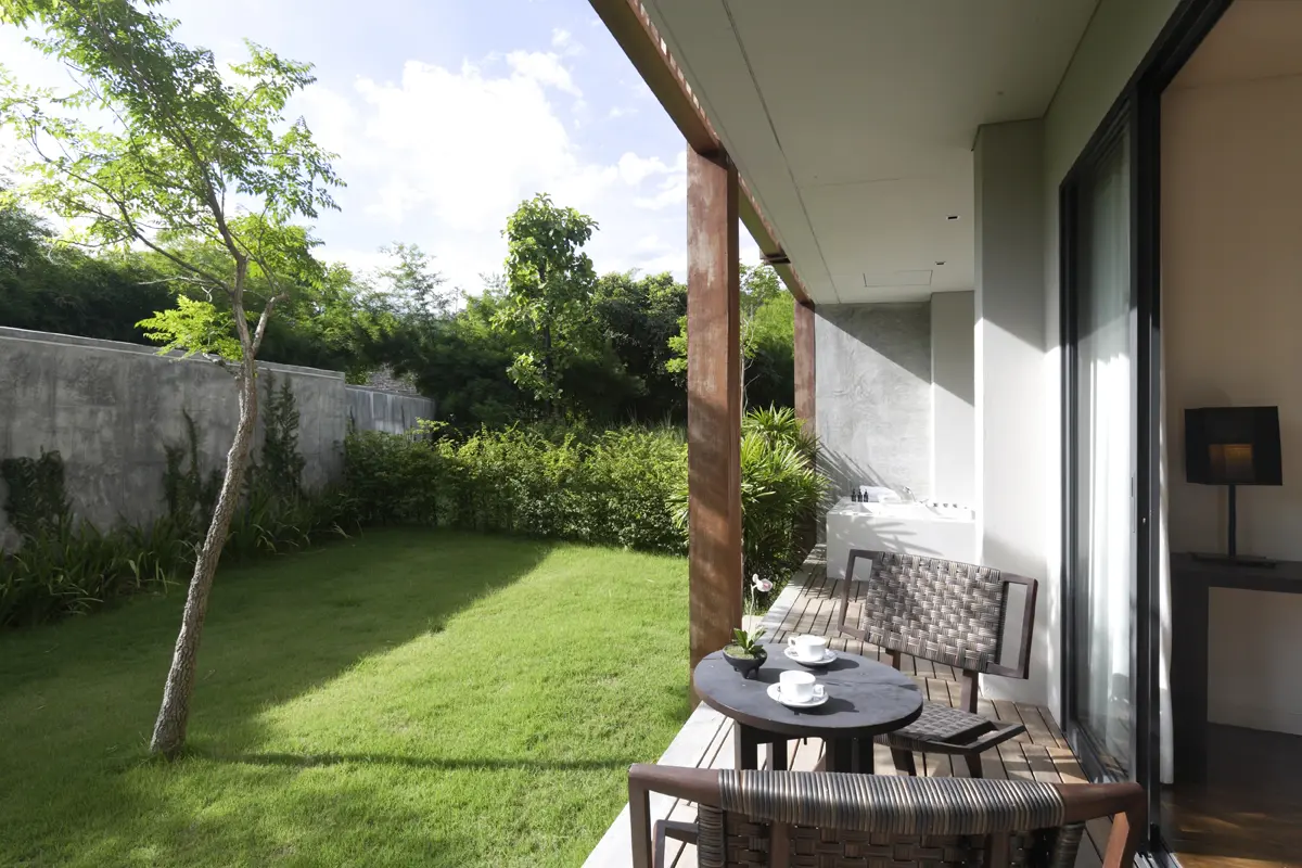 Spacious living area with soft natural lighting and refined boutique styling for a relaxing stay.