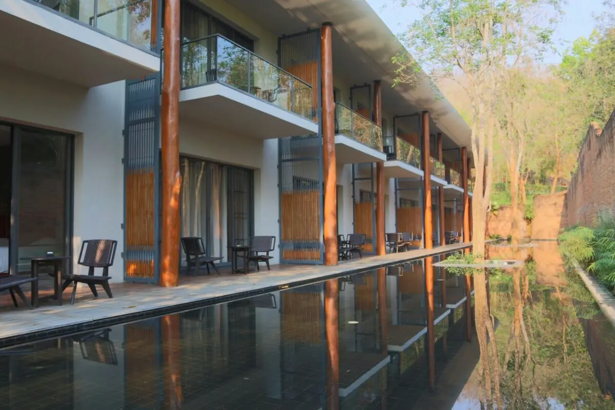 Valley Deluxe room with warm contemporary décor and serene valley views, offering a relaxing stay at a Chiang Mai resort.