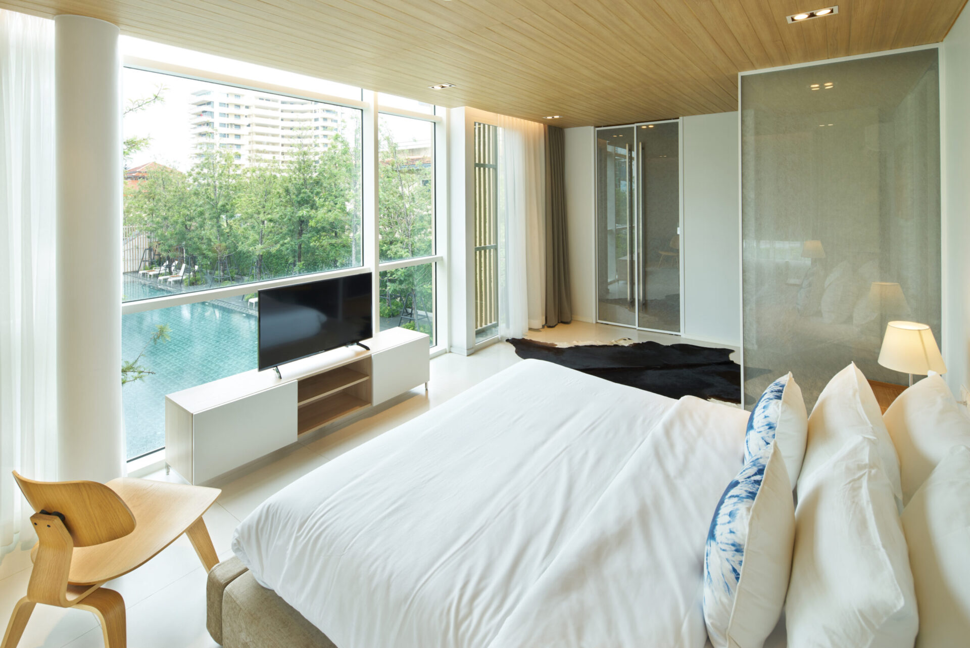 Open-plan living space with pool-facing windows, creating a bright and airy villa environment.