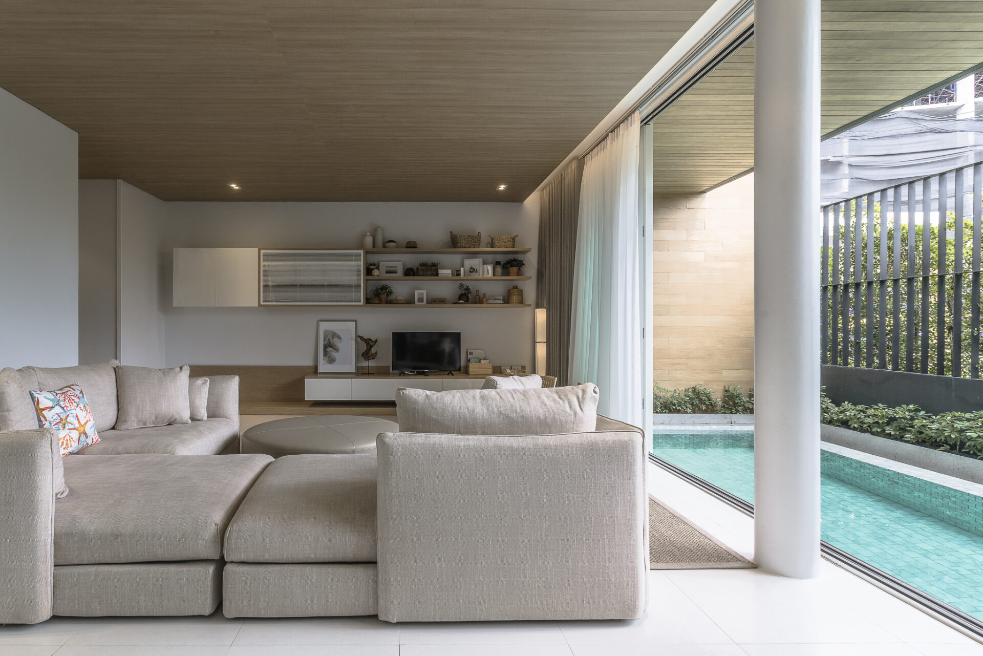 Villa entrance featuring warm wooden accents and inviting tropical style.