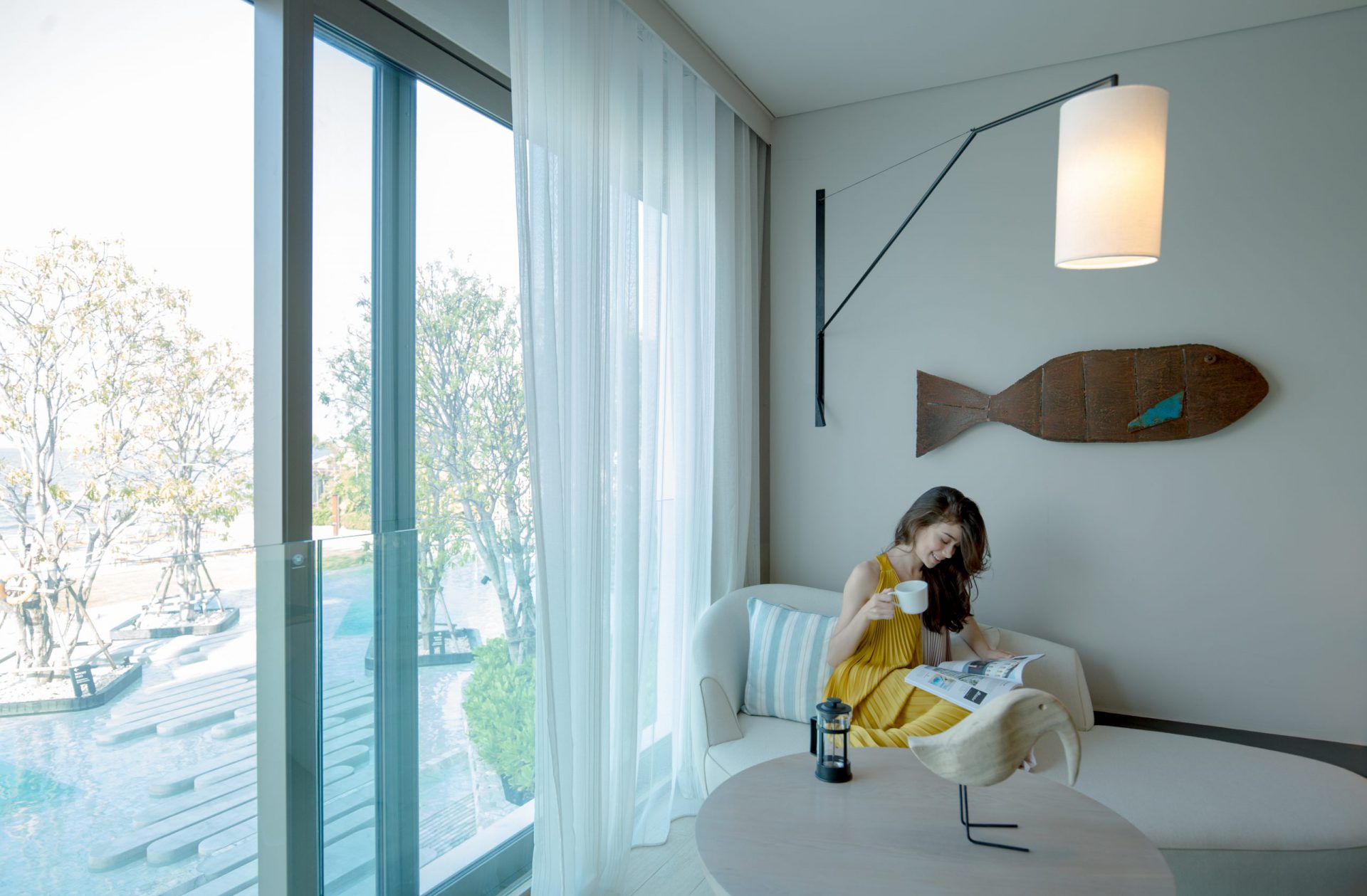 Elegant Ocean Front interior with warm tones and a spectacular ocean horizon, designed for comfort at a 5-star Na Jomtien hotel.