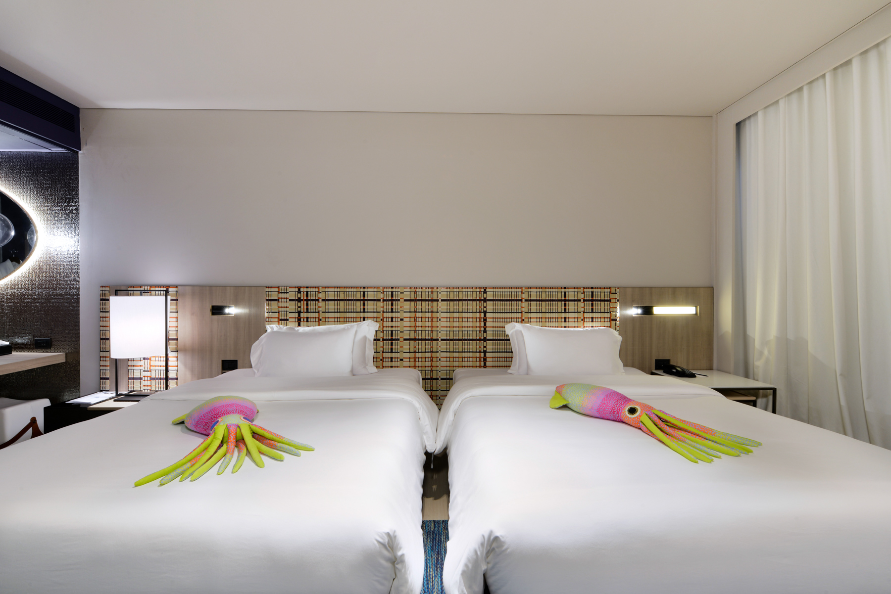 Elegant Seascape Deluxe interior with double queen beds and stylish décor, creating a cozy and refreshing stay at a Na Jomtien beachfront hotel.