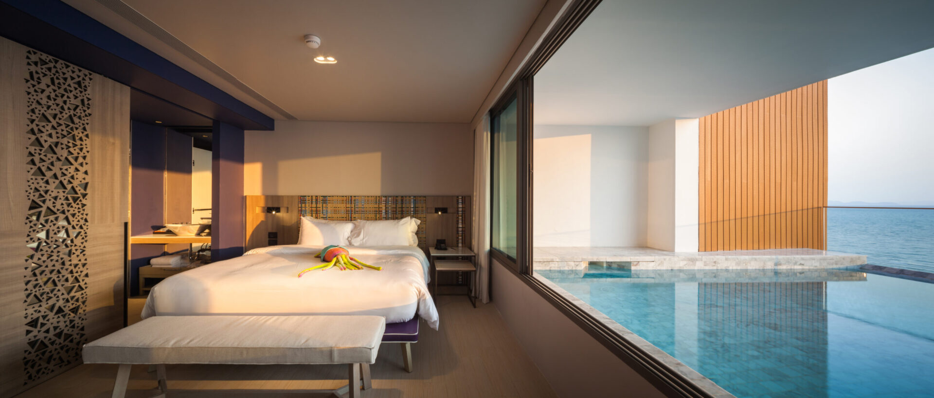 Elegant villa interior with contemporary styling and floor-to-ceiling glass showcasing Pattaya’s coastline.
