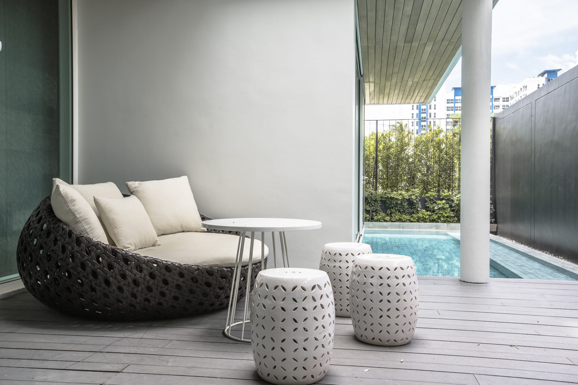 Outdoor terrace with lounge seating and clear pool view, perfect for relaxing mornings.