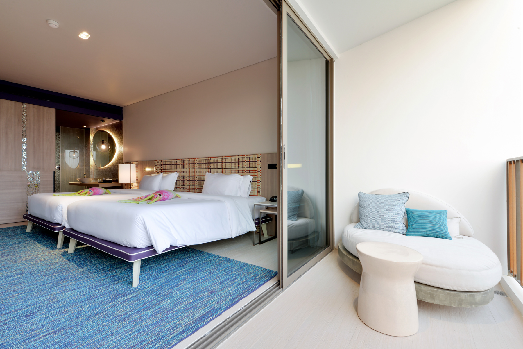 Seascape Deluxe room with two comfortable queen beds and modern coastal décor, offering a relaxing stay at a Pattaya beachfront hotel in Na Jomtien.