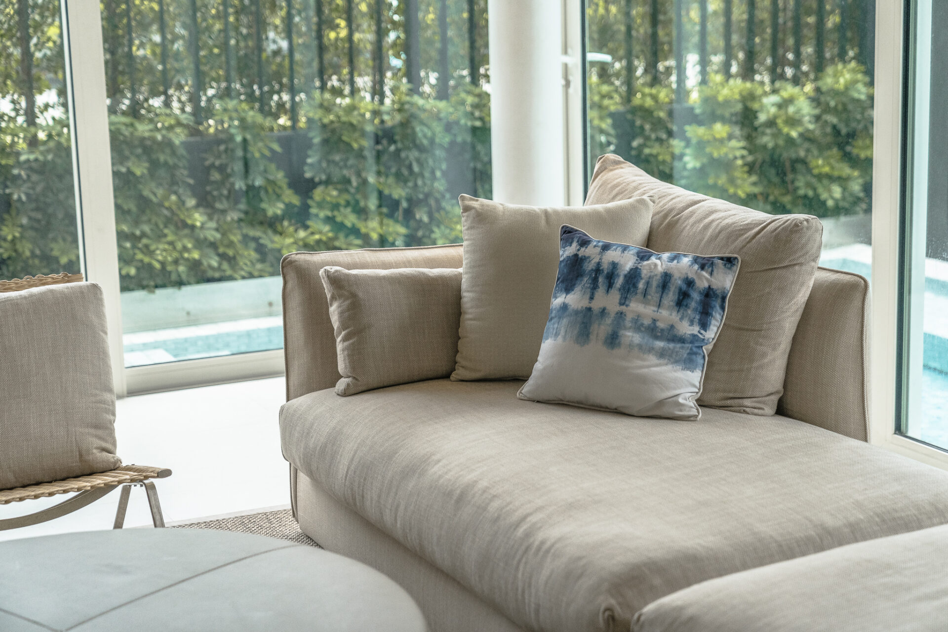 Contemporary master bedroom featuring soft tones and calming pool scenery for a peaceful stay.