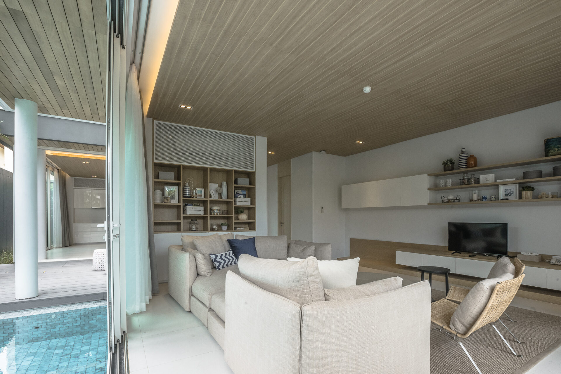 Private pool surrounded by lush greenery, creating a tranquil villa experience for families and friends.