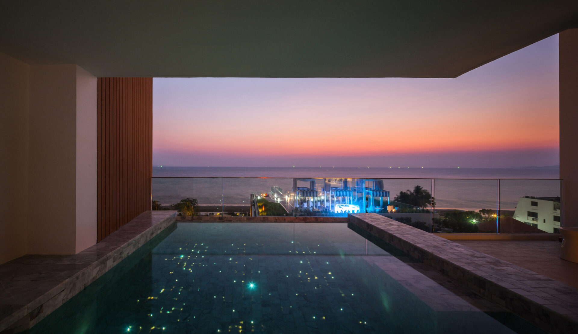 Contemporary Sky Pool Villa living area with warm tones and full ocean view, perfect for families or groups.