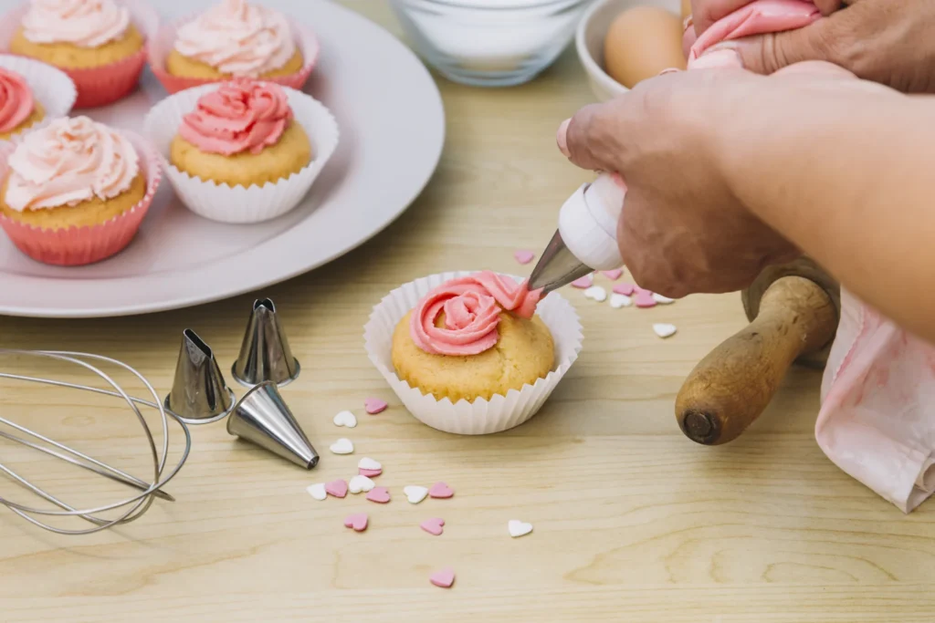 baker decorates muffins with cream wooden desk 2048x1365 1 – Veranda Resort Pattaya Na Jomtien